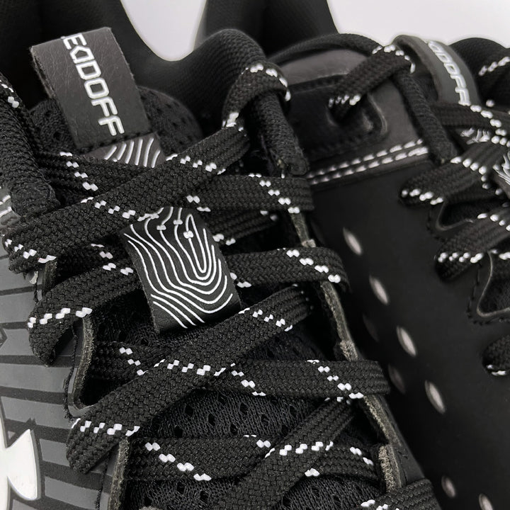 detail of baseball shoes under armour, color black